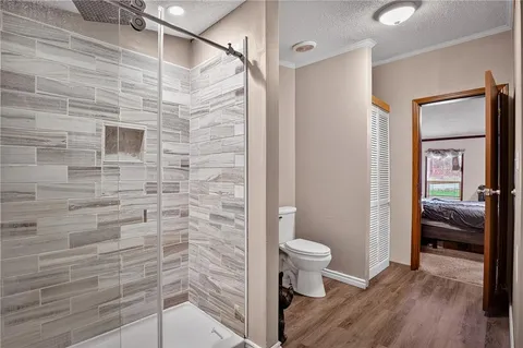 a bathroom with a toilet and a shower