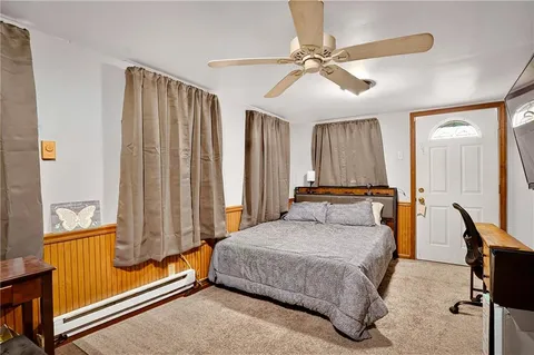 a bedroom with a bed and a chandelier