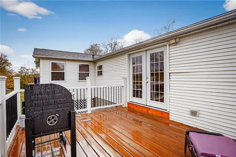 a view of a house with wooden deck