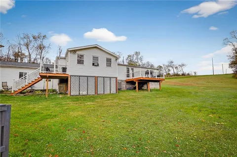 a view of a house with a yard and sitting area