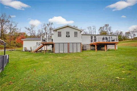 a view of a house with a yard and sitting area