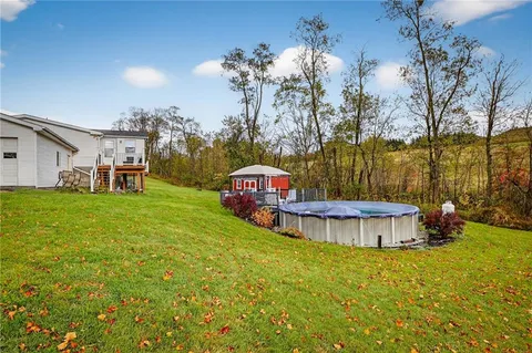 a view of a house with a yard and sitting area