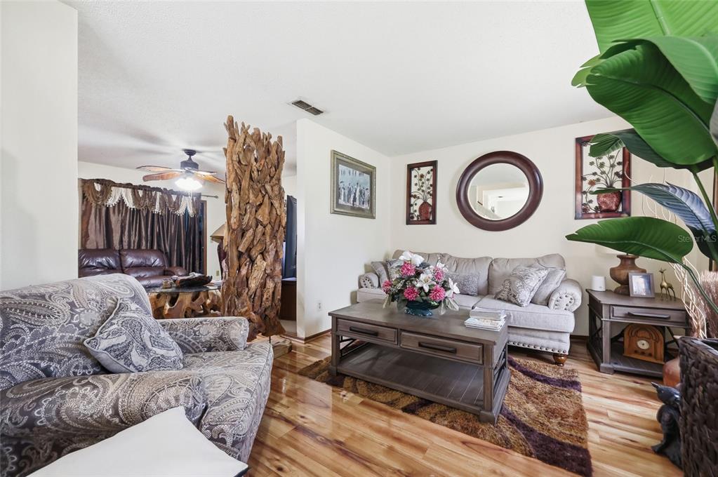 3027 Queens Gate Road Orlando, FL 32818 - Photo 9 of 34 a living room with furniture and a window