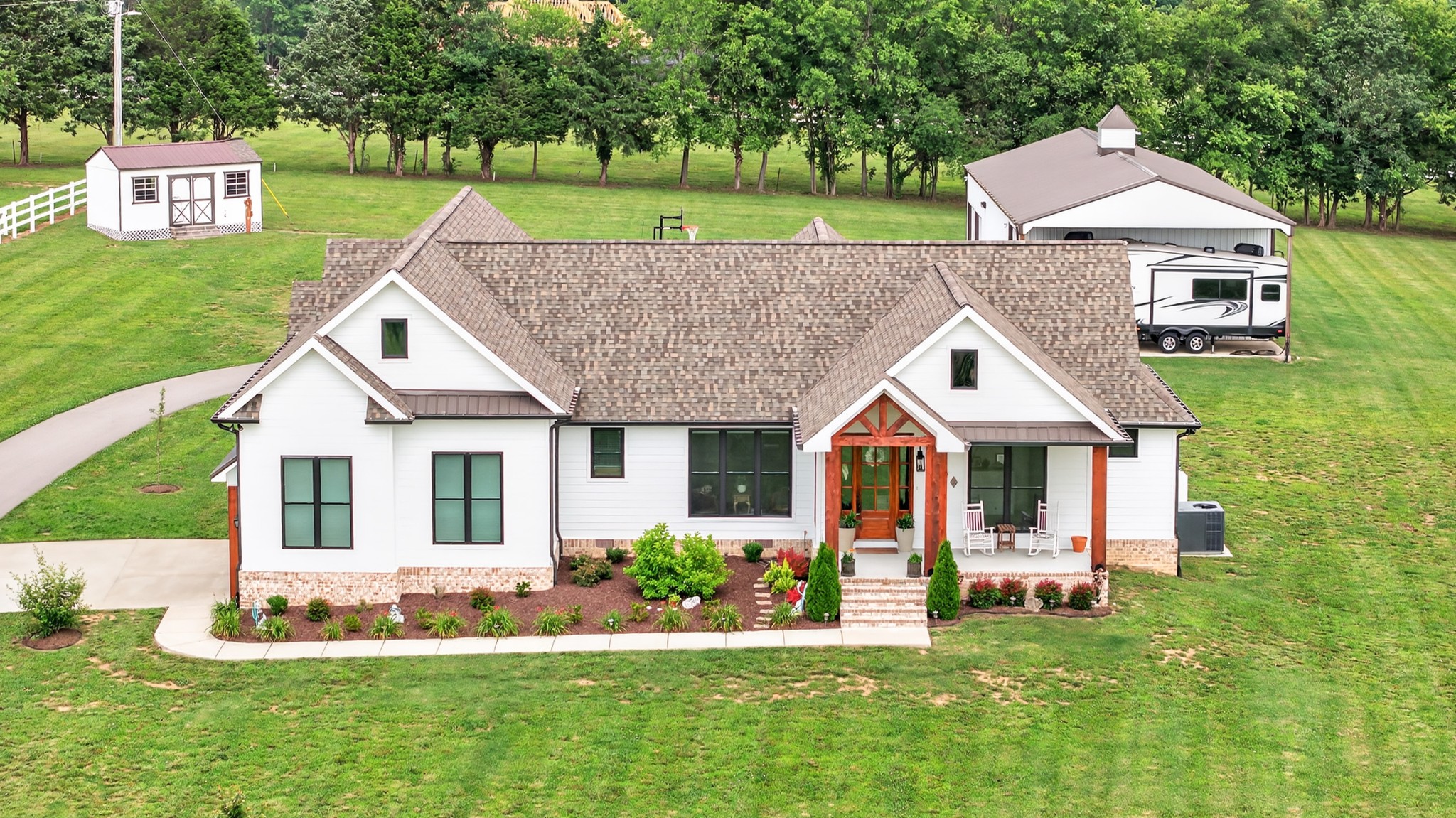 7040 Highway 231 Bethpage, TN 37022 - Photo 72 of 83 a aerial view of a house with a yard table and chairs