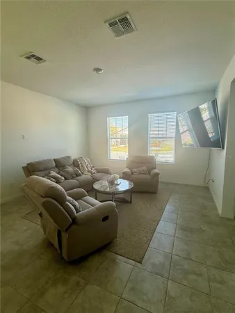 a living room with furniture and a window