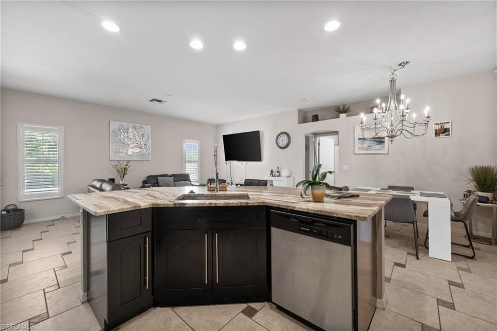 2017 Cape Coral Parkway West Cape Coral, FL 33914 - Photo 35 of 35 Kitchen with dishwasher, open floor plan, a chandelier, plenty of natural light, and recessed lighting