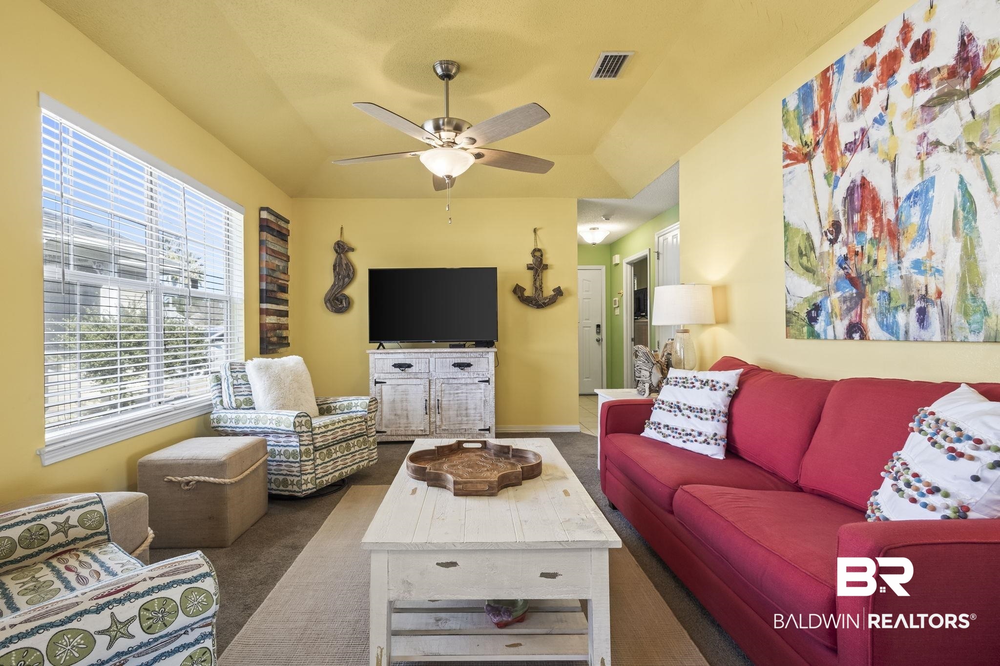 Living room featuring dark carpet and ceiling fan