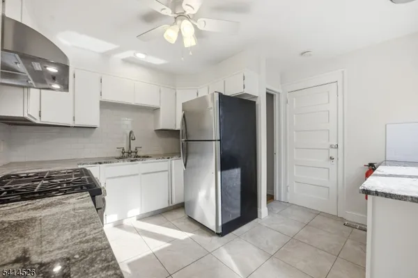 a kitchen with a refrigerator and a sink