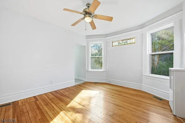 a view of a room with wooden floor and a window