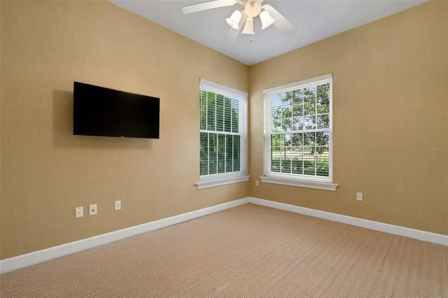 an aerial view of a house with a yard and lake view