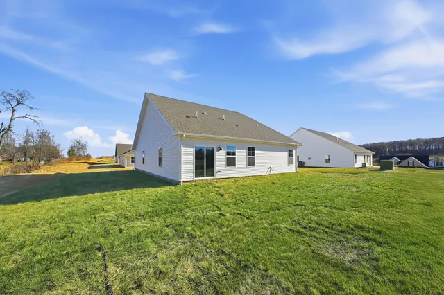 a house view with garden space and trees