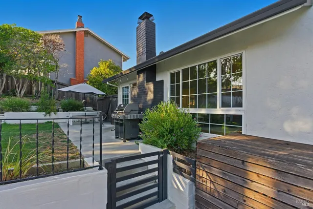 a house view with a sitting space and garden space