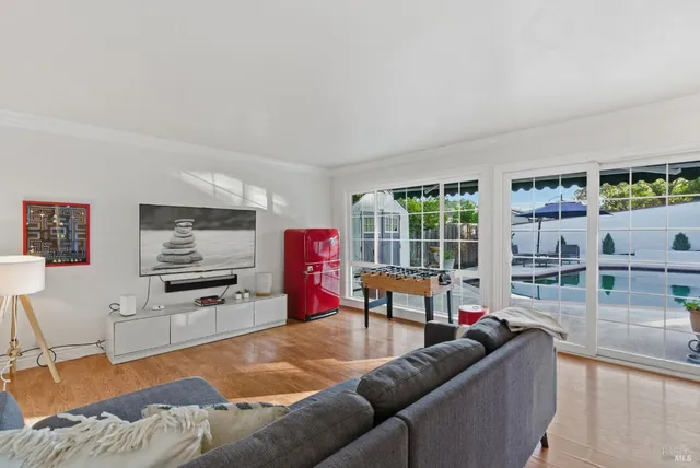 a living room with furniture window and a flat screen tv