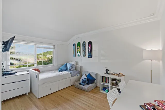 a bedroom with furniture and a large window