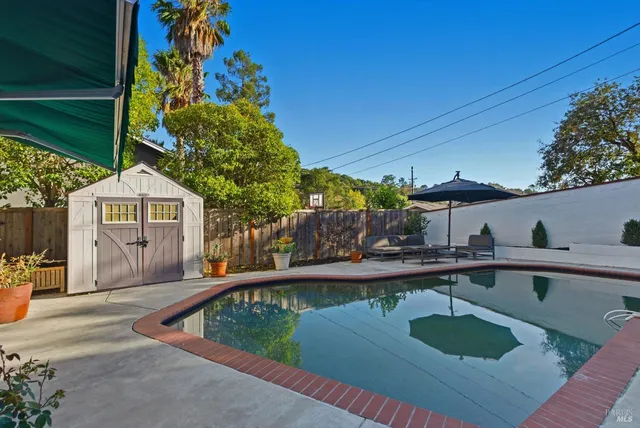 a view of a swimming pool with a patio