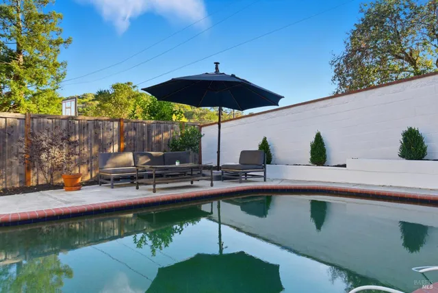 a view of swimming pool with outdoor seating