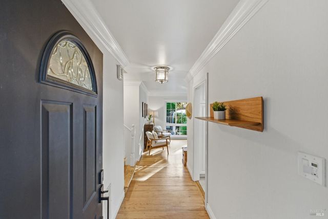 a view of a hallway to a livingroom with furniture