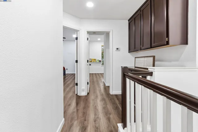 a kitchen with a sink and wooden floor