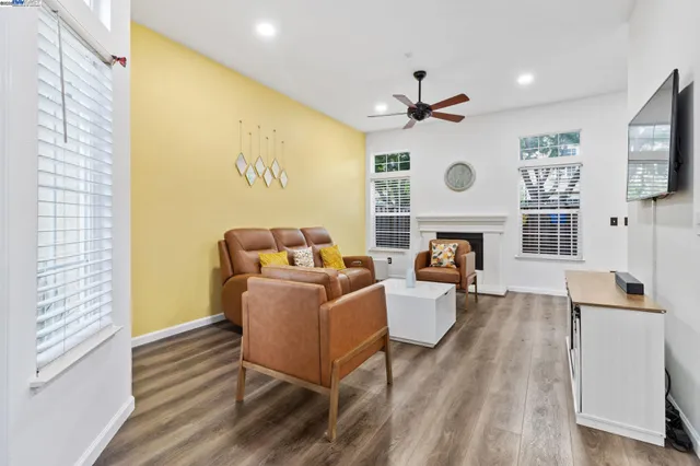 a living room with fireplace furniture and a large window