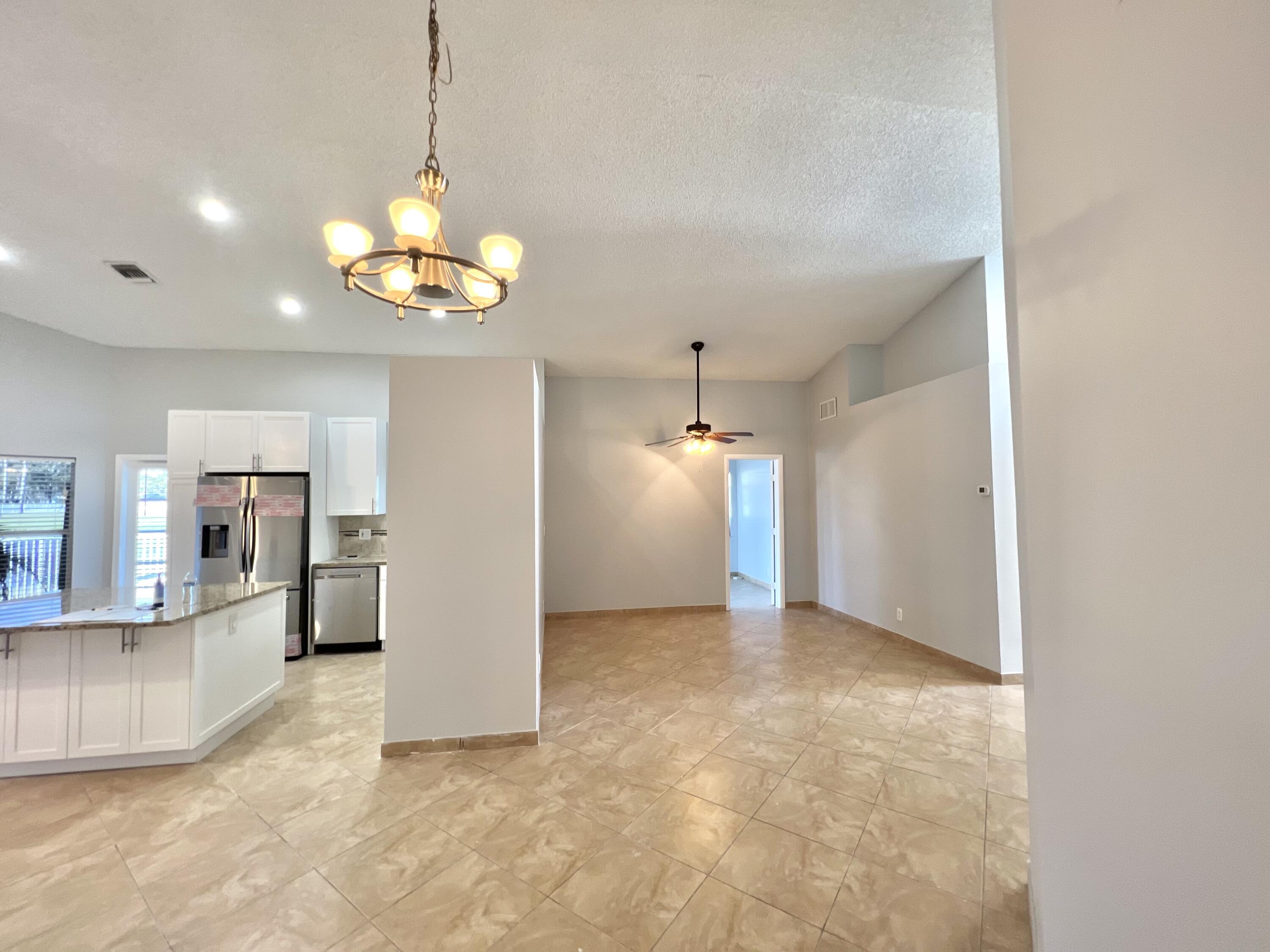 18859 La Costa Lane Boca Raton, FL 33496 - Photo 15 of 16 a view of a kitchen with a refrigerator and a chandelier