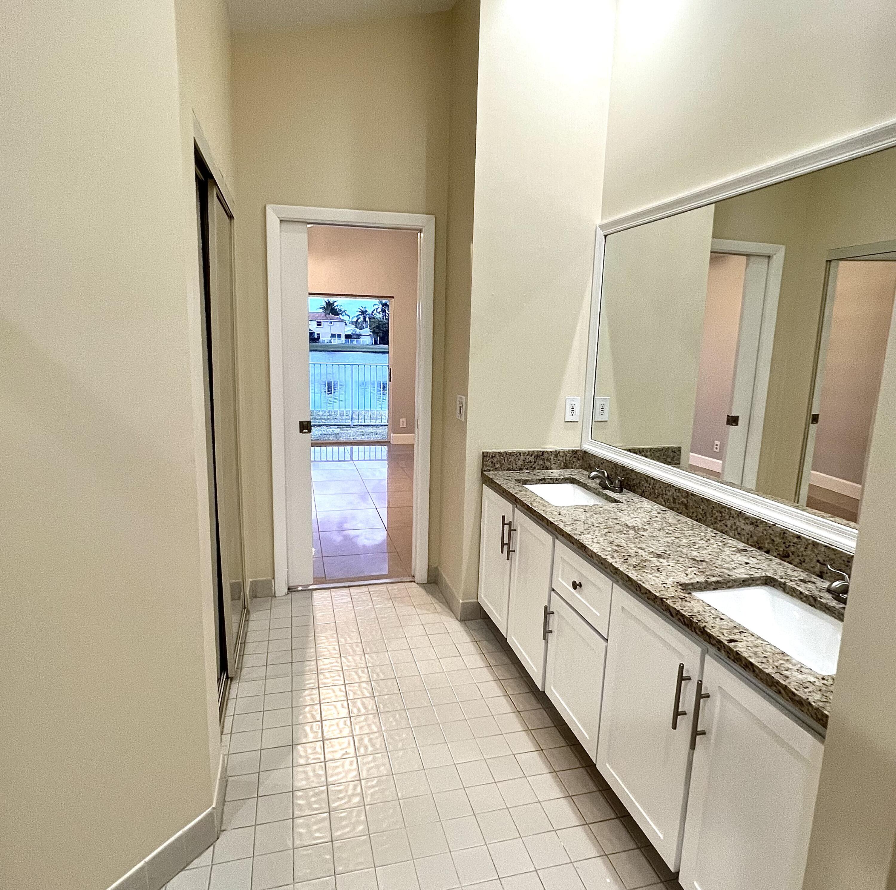 18859 La Costa Lane Boca Raton, FL 33496 - Photo 8 of 16 a bathroom with a granite countertop sink and a mirror