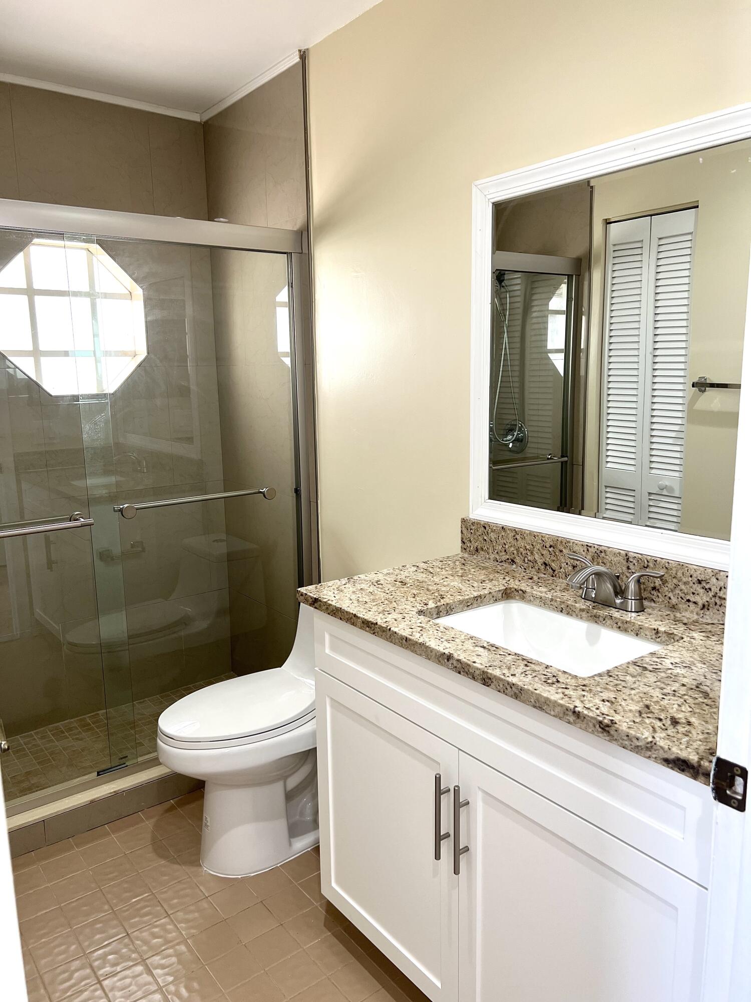 18859 La Costa Lane Boca Raton, FL 33496 - Photo 10 of 16 a bathroom with a granite countertop toilet a sink and a mirror