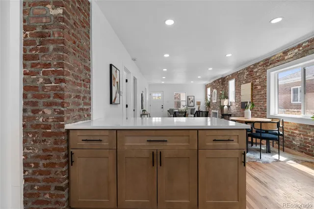 a kitchen with cabinets and chairs