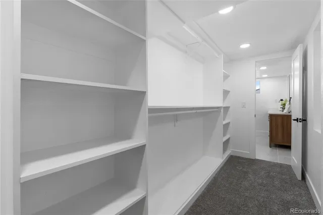 a view of walk in closet with empty racks