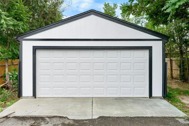a small white house with outdoor space