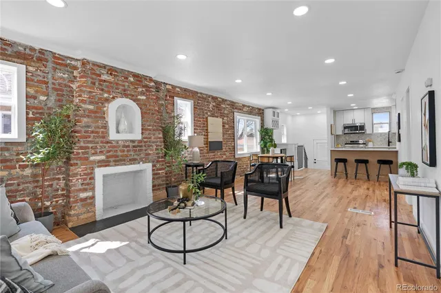 a living room with furniture a dining table and kitchen view
