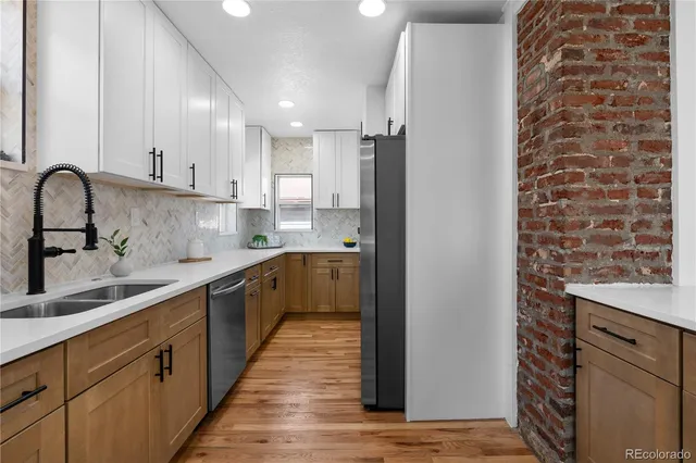 a kitchen with a sink stove and cabinets