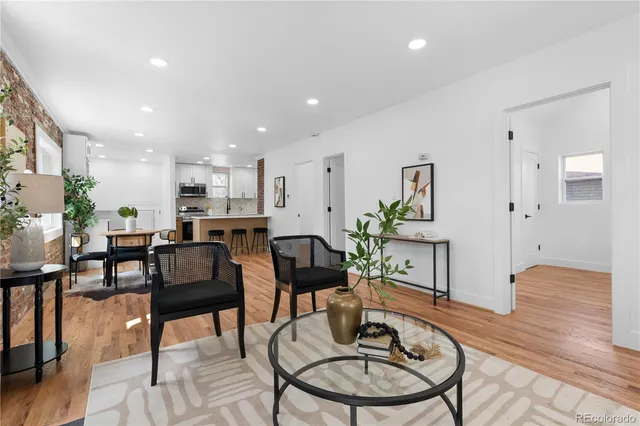 a living room with furniture and kitchen view