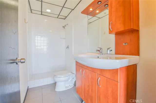 a view of a kitchen with a sink and a refrigerator
