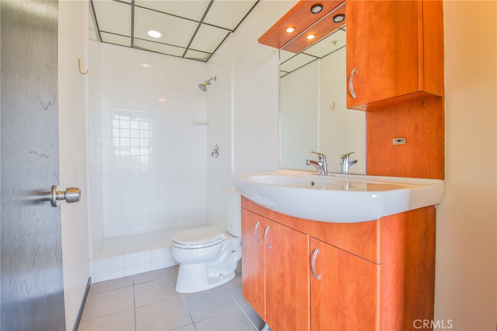 108 West 2nd Street, Unit 803 Los Angeles, CA 90012 - Photo 12 of 28 a bathroom with a sink toilet and shower