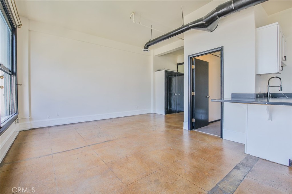 108 West 2nd Street, Unit 803 Los Angeles, CA 90012 - Photo 13 of 28 a view of a kitchen with a sink and a refrigerator
