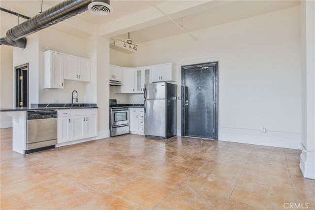 a view of a kitchen with a sink and cabinet