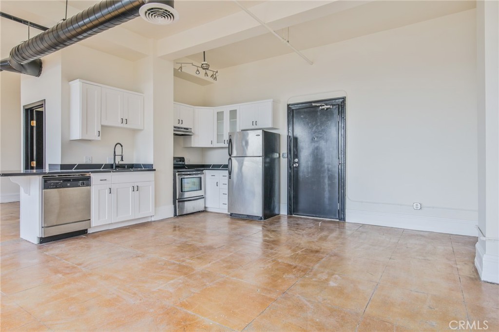 108 West 2nd Street, Unit 803 Los Angeles, CA 90012 - Photo 10 of 28 a kitchen with stainless steel appliances granite countertop a refrigerator and a stove