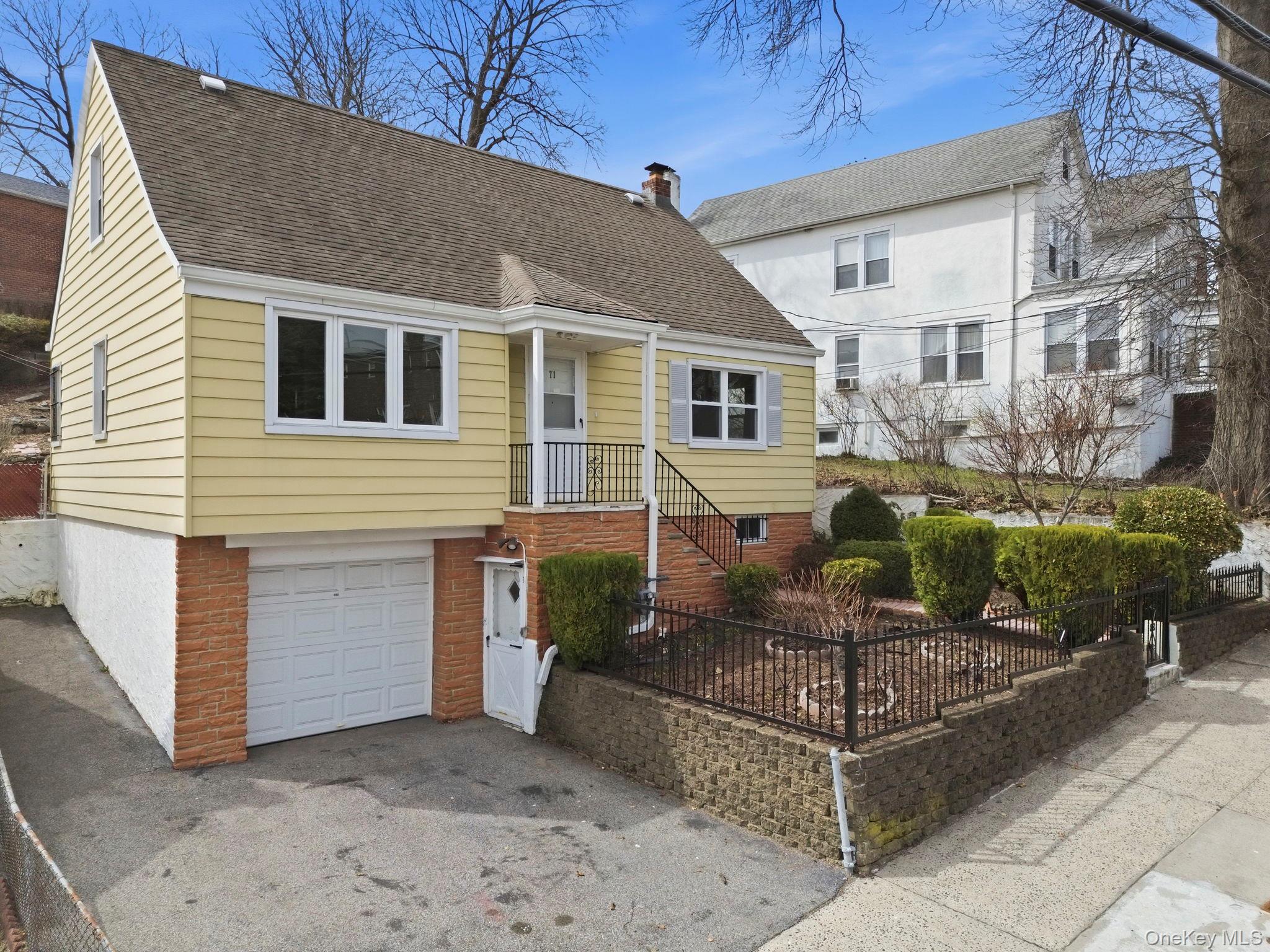 71 Glen Road Yonkers, NY 10704 - Photo 2 of 30 a front view of a house with a yard