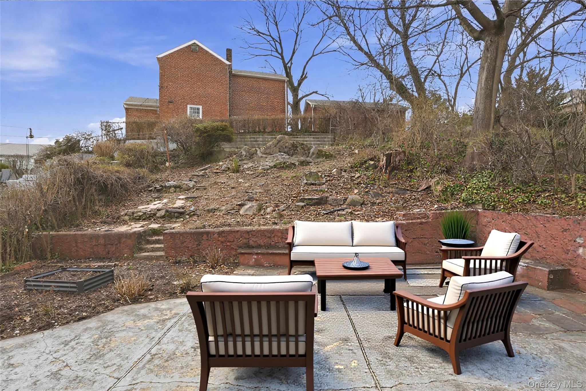 71 Glen Road Yonkers, NY 10704 - Photo 23 of 30 a view of a terrace with furniture and a fire pit
