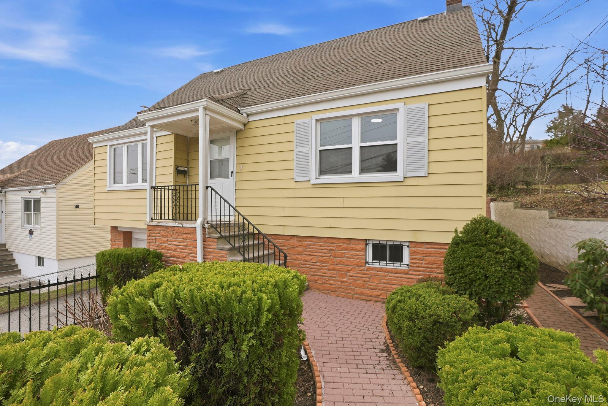 71 Glen Road Yonkers, NY 10704 - Photo 24 of 30 a front view of a house with a yard