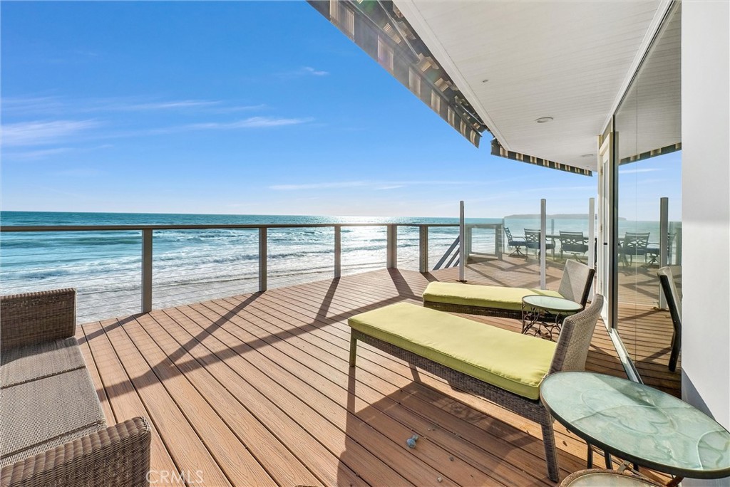 35781 Beach Road Dana Point, CA 92624 - Photo 1 of 58 a view of a balcony with chairs and wooden floor