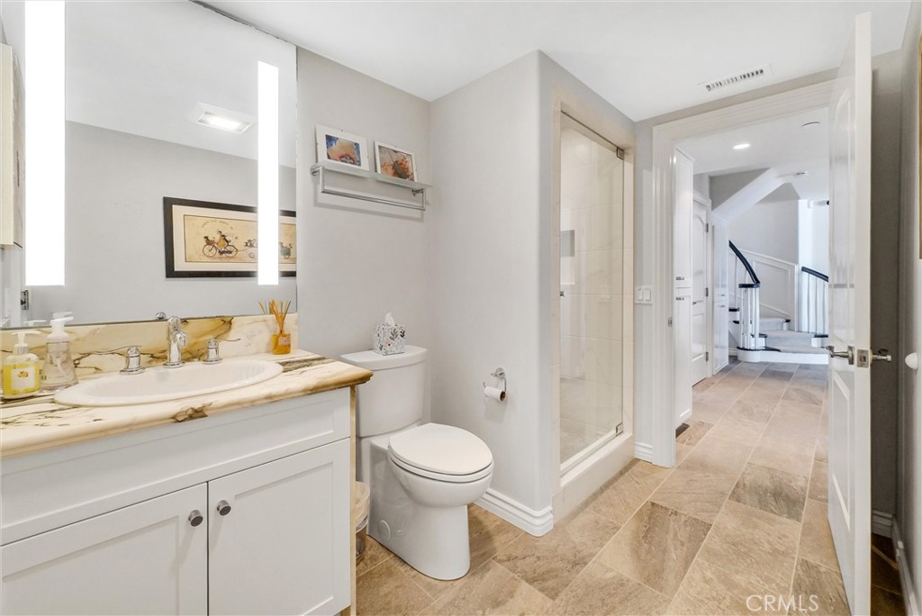 35781 Beach Road Dana Point, CA 92624 - Photo 20 of 58 a bathroom with a granite countertop sink a toilet and a shower