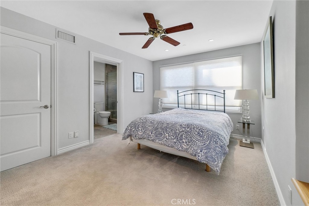 35781 Beach Road Dana Point, CA 92624 - Photo 26 of 58 a bedroom with a bed and a ceiling fan