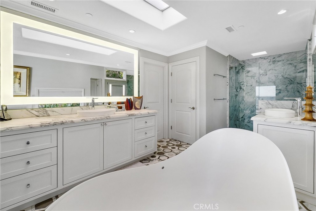 35781 Beach Road Dana Point, CA 92624 - Photo 42 of 58 a bathroom with a sink double vanity and a shower