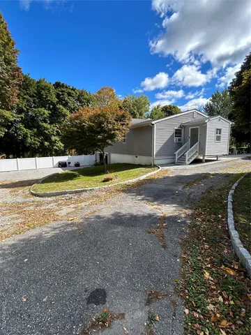 a view of a house with swimming pool and a yard