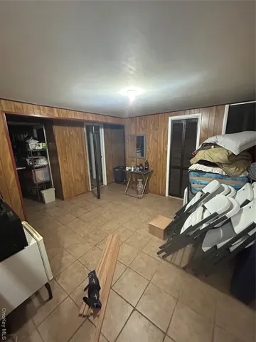a view of a kitchen with kitchen island a counter top space a sink stainless steel appliances and cabinets