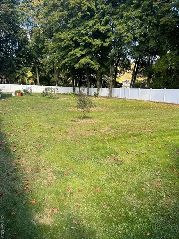 a view of yard with swimming pool and trees