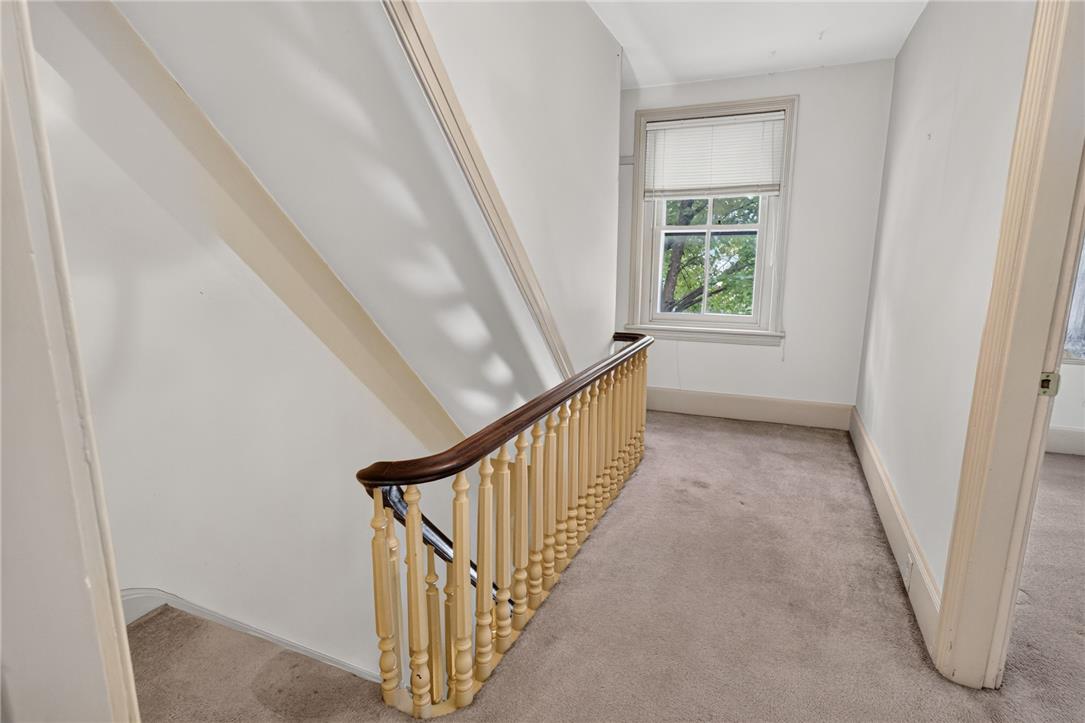 765 East Macada Road Bethlehem, PA 18017 - Photo 25 of 46 Well-lit landing space features a charming wooden banister and a window offering views of mature trees.