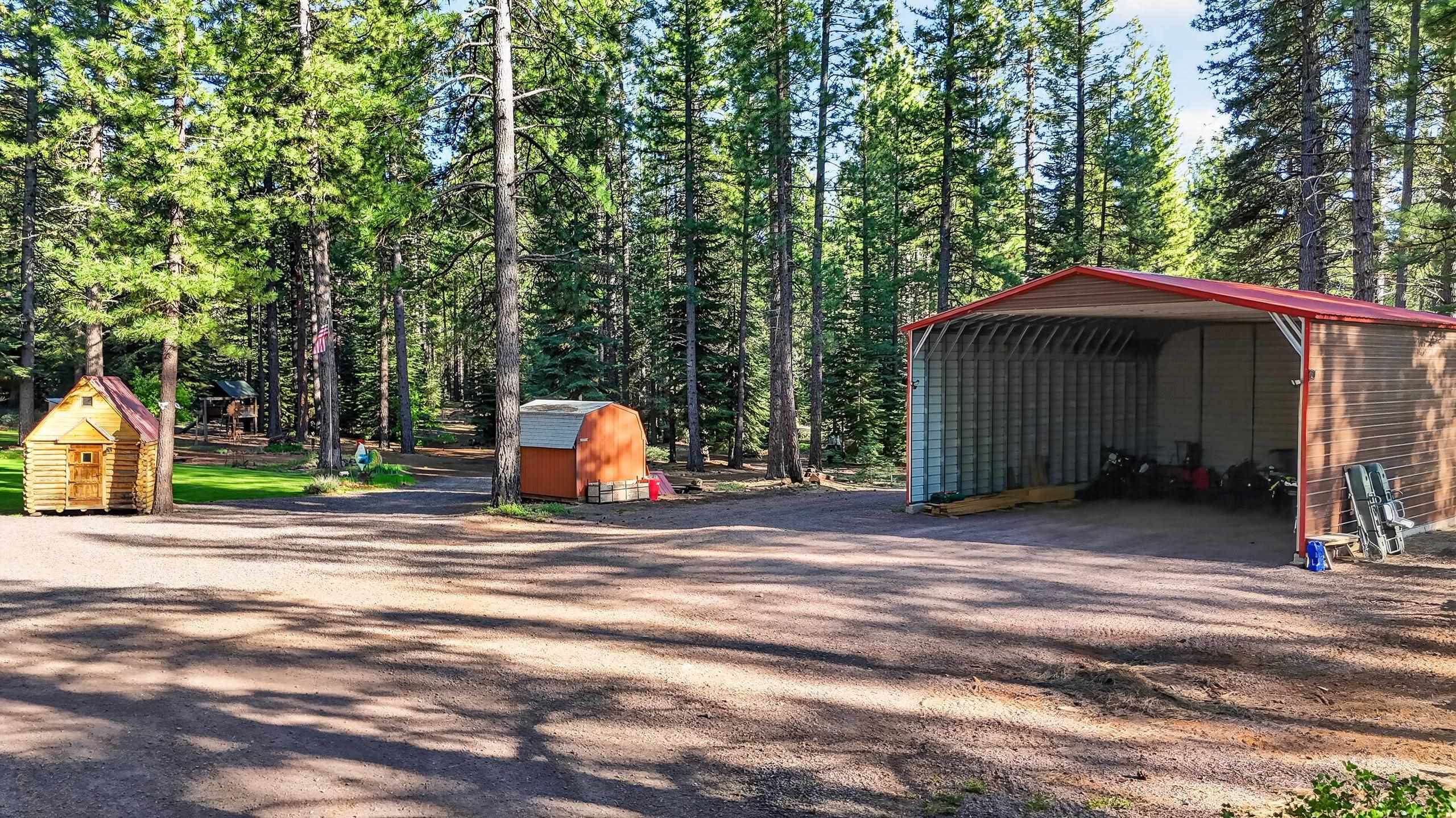 463-000 Moonlight Ranch Rd Westwood Road Susanville, CA 96130 - Photo 34 of 46 a backyard of a house with large trees and entertaining space