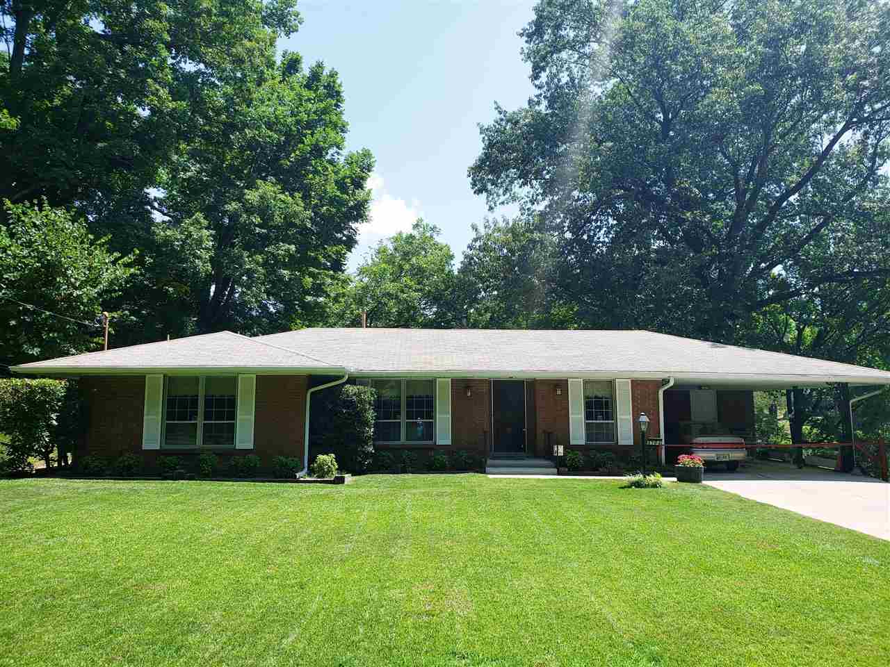a view of an house with backyard space and balcony